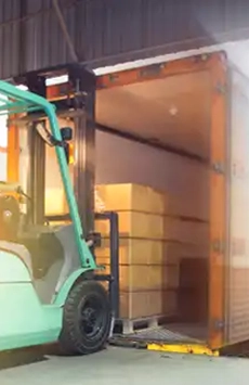 Pallets of clothes being loaded onto a truck